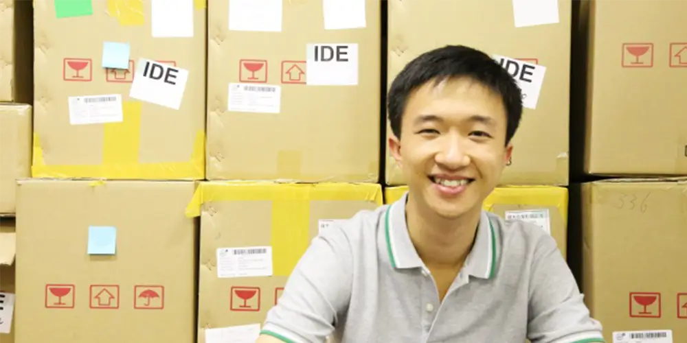 ide employee kong sits in front of boxes