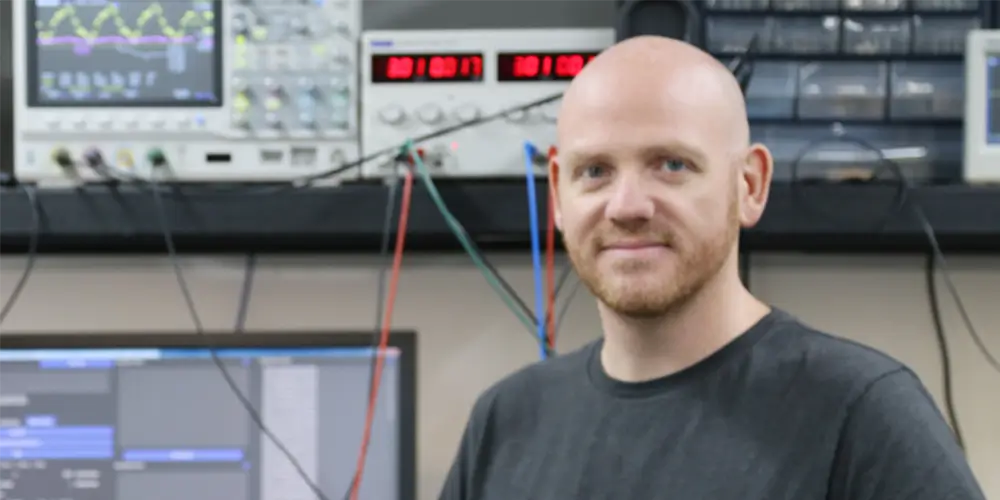 aaron russell stands in electrical engineering lab